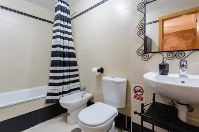 a bathroom with a toilet and a sink at Puerta San FELIX free parking by Cadiz4Rentals in Cádiz