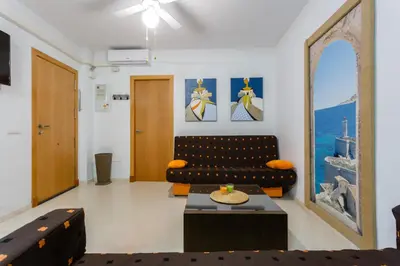 a living room with a couch and a table at Puerta San FELIX free parking by Cadiz4Rentals in Cádiz