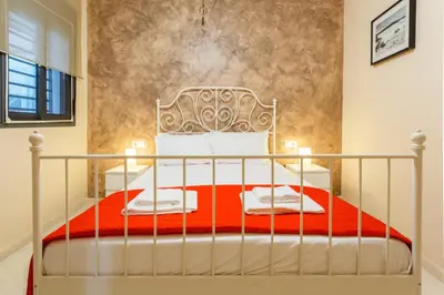 a bedroom with a bed with a red blanket at Puerta San FELIX free parking by Cadiz4Rentals in Cádiz