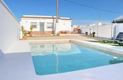 a swimming pool in the backyard of a house at Casa Colorado con piscina in Conil de la Frontera