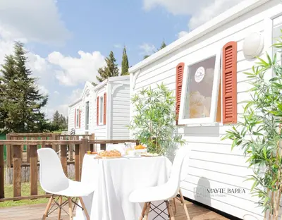 a white house with a table and chairs on a deck at Hotel La Villoría in Medina Sidonia