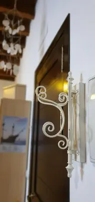 a bed with a metal head board with pillows and a seahorse at Palacio Godoy in Sanlúcar de Barrameda