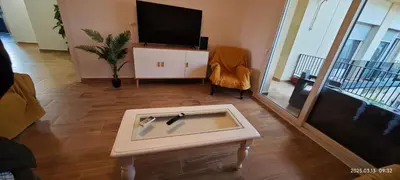 a living room with a tv and a coffee table at JEREZ CENTRO 5 DORMITORIOS TERRAZAS CON VISTAS ALCAZAR Y PLAZA ARENAL in Jerez de la Frontera