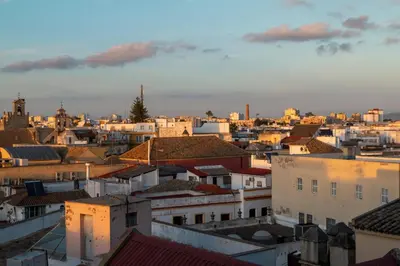 a view of a city at sunset at JEREZ CENTRO 5 DORMITORIOS TERRAZAS CON VISTAS ALCAZAR Y PLAZA ARENAL in Jerez de la Frontera