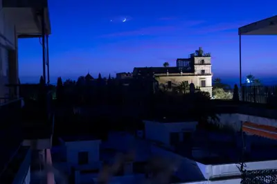 a light house in a city at night at JEREZ CENTRO 5 DORMITORIOS TERRAZAS CON VISTAS ALCAZAR Y PLAZA ARENAL in Jerez de la Frontera