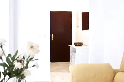 a living room with a couch and a door at City CENTER and Free PARKING apartment in Jerez de la Frontera