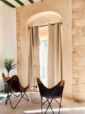 two chairs and a table in front of a window at Feel the Sherry experience1 by Musgo in Jerez de la Frontera