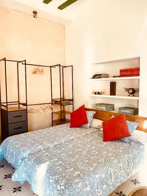 a bedroom with a bed with red pillows at Feel the Sherry experience1 by Musgo in Jerez de la Frontera