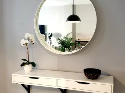 a white dressing table with a mirror on the wall at Sherryflat Palacio - Parking in Jerez de la Frontera