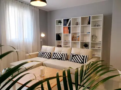 a living room with a couch and a table at Sherryflat Palacio - Parking in Jerez de la Frontera