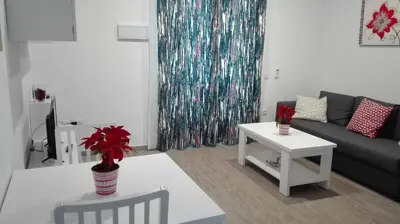 a living room with a couch and a table at Apartamento Centro Sol Plazuela in Jerez de la Frontera