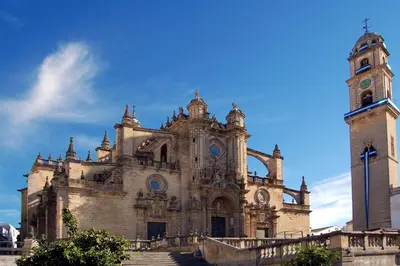 a large building with a clock tower and stairs at Apartamento Centro Sol Plazuela in Jerez de la Frontera