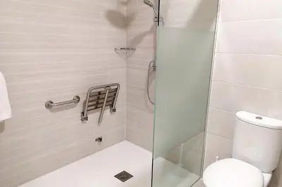 a bathroom with a shower with a toilet at Apartamentos Jerez Plaza in Jerez de la Frontera