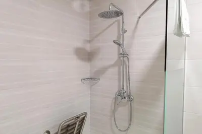 a shower with a glass door in a bathroom at Apartamentos Jerez Plaza in Jerez de la Frontera