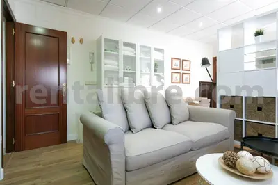 a living room with a white couch and a table at Loft24Sanlúcar in Sanlúcar de Barrameda