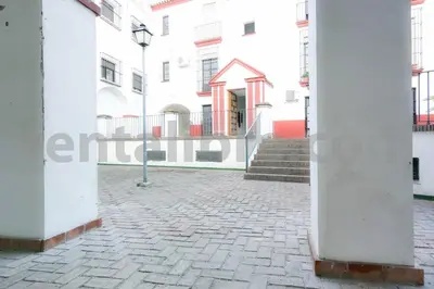a large white building with stairs in front of it at Loft24Sanlúcar in Sanlúcar de Barrameda