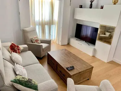 a living room with a couch and a coffee table at Puerta de Santa Maria Grupo AC Gestion in Cádiz