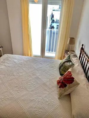 a bedroom with a large white bed with a window at Puerta de Santa Maria Grupo AC Gestion in Cádiz
