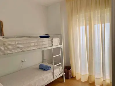 a bunk bed in a room with a window at Puerta de Santa Maria Grupo AC Gestion in Cádiz