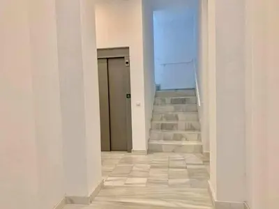 an empty hallway with stairs and a door at Puerta de Santa Maria Grupo AC Gestion in Cádiz
