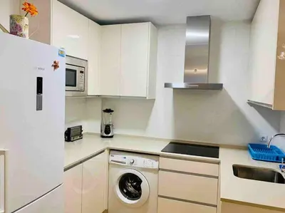 a white kitchen with a washing machine in it at Puerta de Santa Maria Grupo AC Gestion in Cádiz