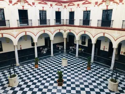 a room with a checkered floor in a building at Hotel Boutique Convento Cádiz in Cádiz