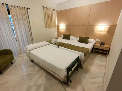 a hotel room with two beds in a room at Hotel Boutique Convento Cádiz in Cádiz
