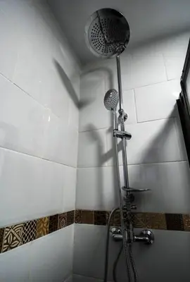 a shower with a shower head in a bathroom at SH L'Azotea D'Horozco. Ático con terraza. AC, WiFi in Cádiz