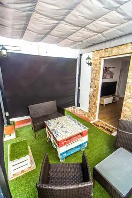 a living room with a table and chairs and a couch at SH L'Azotea D'Horozco. Ático con terraza. AC, WiFi in Cádiz