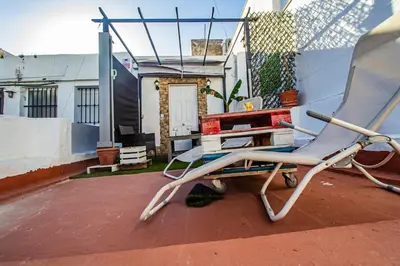 a chair sitting on a patio in front of a house at SH L'Azotea D'Horozco. Ático con terraza. AC, WiFi in Cádiz