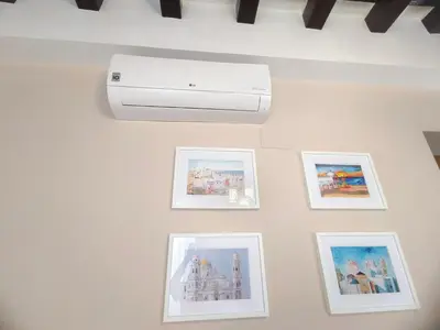 a wall with pictures and a printer on it at La Viña (centro histórico) in Cádiz