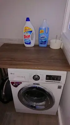 a washing machine with two bottles of detergent on a counter at La Viña (centro histórico) in Cádiz
