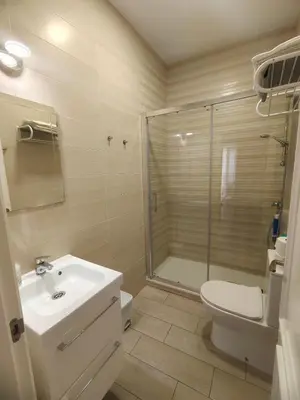 a bathroom with a toilet and a sink and a shower at La Viña (centro histórico) in Cádiz