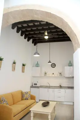 a living room with a couch and a table at CASA ARCO DEL CAÑÓN - Casita con Encanto in Medina Sidonia