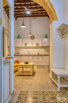 a kitchen with a table in the middle of a room at CASA ARCO DEL CAÑÓN - Casita con Encanto in Medina Sidonia