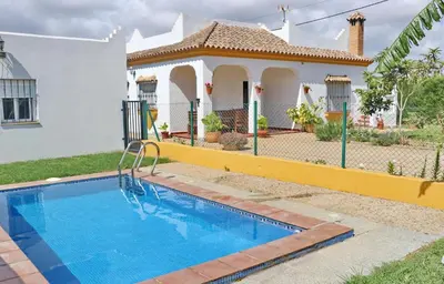 a swimming pool in front of a house at Chalet Pilahito in Conil de la Frontera