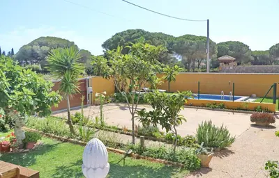 a garden with trees and a swimming pool at Chalet Pilahito in Conil de la Frontera
