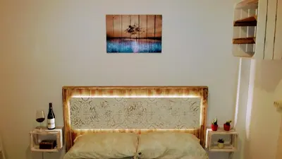 a bedroom with a bed and a picture on the wall at Apartamento Jerez Terraza Privada in Jerez de la Frontera