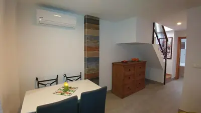 a dining room with a table with a candle on it at Apartamento Jerez Terraza Privada in Jerez de la Frontera