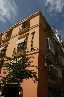a building with a sign on the side of it at Hostal Bahía in Cádiz