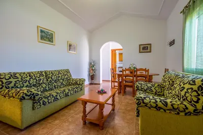a living room with two couches and a table at Chalet Pedro III in Conil de la Frontera