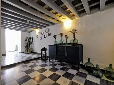 a room with a black dresser with vases on it at TRIPERIA 25 in Medina Sidonia