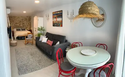 a living room with a table and a couch at TRIPERIA 25 in Medina Sidonia