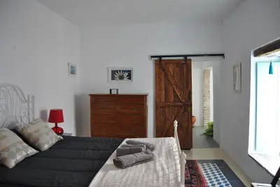 a bedroom with a bed and a dresser in it at Casa-Palacio La Casa Empeño en Centro Histórico in Arcos de la Frontera