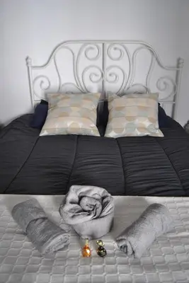 a bed with a blanket andjeweledeled shoes on it at Casa-Palacio La Casa Empeño en Centro Histórico in Arcos de la Frontera