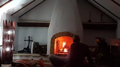 a person sitting in front of a brick oven at Casa-Palacio La Casa Empeño en Centro Histórico in Arcos de la Frontera