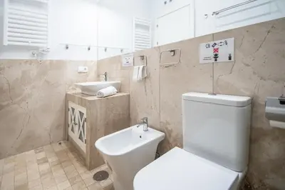 a bathroom with a white toilet and a sink at Apartamento Relax in Cadiz in Cádiz