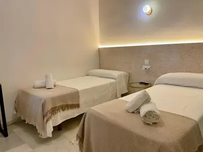 a white bathroom with a sink and a shower at BOHEMIA SANLUCAR in Sanlúcar de Barrameda
