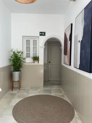 a room with a bed with a table in it at BOHEMIA SANLUCAR in Sanlúcar de Barrameda