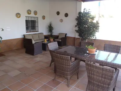 a patio with a table and chairs anditures at ABULAGAR in Rota